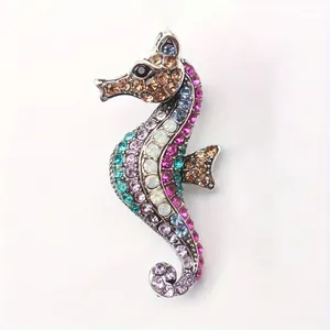 Macro view of a vibrant seahorse brooch embellished with multi-colored sparkling rhinestones.
