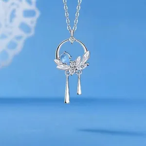 Elegant silver necklace with moonstone blue gem and leaf pendant design