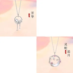 Detailed view of moonstone necklaces with floral tassel and snake moon motifs