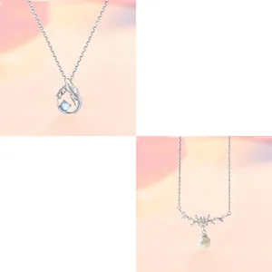 Detail of elegant silver necklace with wing pendant and pearl drop charms