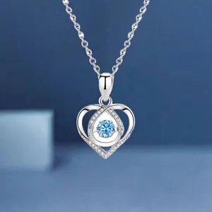 Elegant silver heart necklace featuring a bright blue gemstone and dainty O-chain link.