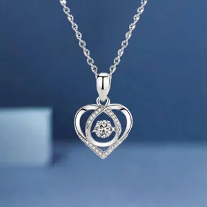 Detailed close-up of a silver heart-shaped necklace with a brilliant gemstone center