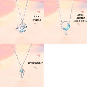 Close-up of 3-piece silver necklace set featuring planet, moon, and dreamcatcher