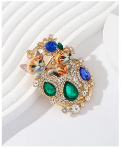 Detailed macro view of a retro double cat brooch with sparkling rhinestones and crystals.