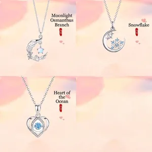 Detail view of a 3-piece silver necklace set featuring moon, snowflake and heart pendants