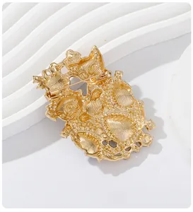 Detailed back view of vintage gold plated double cat brooch showing secure pin closure