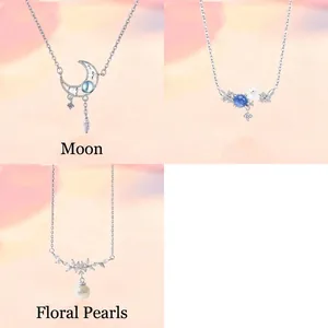 Detail view of 3-piece silver necklace set with moon, flower, and pearl designs