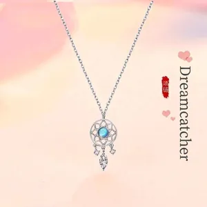 Elegant silver dreamcatcher pendant necklace featuring a central blue moonstone