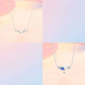 Close-up detail of silver bamboo and blue floral pendant necklaces with minimalist chains