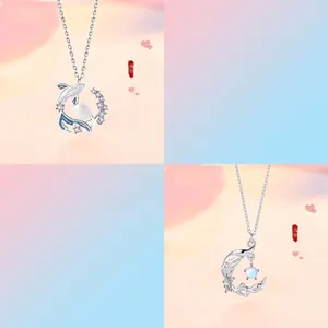 Elegant silver-tone whale and crescent moon necklaces with faux pearl and crystal accents.