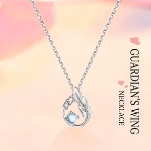 Elegant sterling silver guardian wing necklace featuring a blue moonstone pendant with crystals