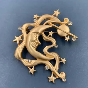 Vintage matte gold man in the moon face brooch with stars and clear crystal accents