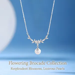 Elegant silver flower necklace with sparkling crystals and a white hanging pearl
