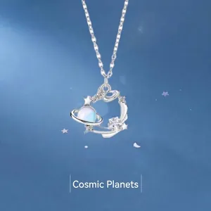 Elegant silver cosmic necklace with iridescent planet and star pendant for women.
