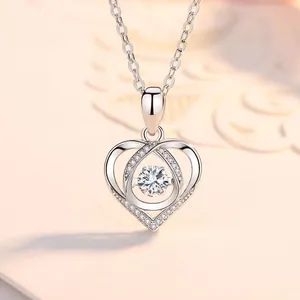 Detailed close-up of a silver heart-shaped necklace with a sparkling dancing stone.