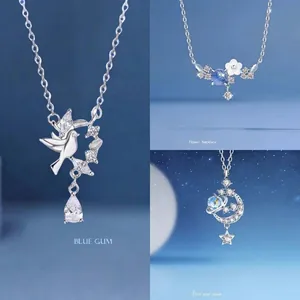 Elegant silver necklace set featuring bird, flower, and star moon motifs with crystals