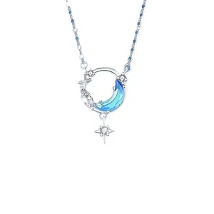 Dromerige zilveren ster en maan ketting met blauwe kristallen hanger