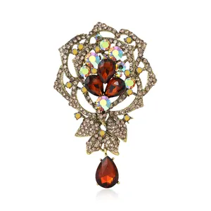 Elegant vintage gold rose brooch featuring brown teardrop crystals and rhinestones