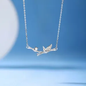 Elegant silver bamboo pendant necklace with small crystal accents on a dainty chain.