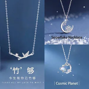 Elegant silver necklace set with bamboo, snowflake moon and planet pendants for women.