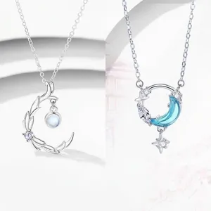 Elegant silver crescent moon necklace featuring blue stone, stars and intricate leaf design
