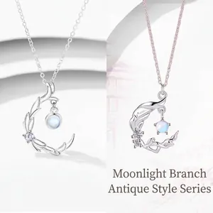 Elegant antique style silver moon branch pendant necklace featuring glowing moonstone gems.