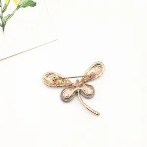 Detailed back view of a gold-plated alloy dragonfly brooch featuring a safety pin closure
