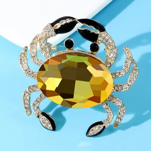 Macro shot of a luxury crab brooch with large yellow crystal and rhinestone detailing
