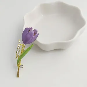 Detailed macro view of an elegant purple enamel tulip brooch with rhinestone accents