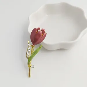 Detailed view of an elegant burgundy tulip brooch with sparkling rhinestones and enamel