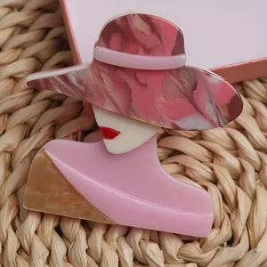 Detailed view of modern lady brooch in pink acrylic with marble pattern hat