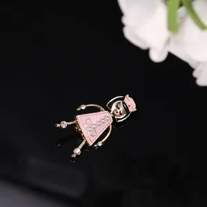 Detailed view of a pink enamel nurse brooch featuring small pearls and crystal accents
