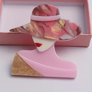 Detailed close-up of artistic fashion lady brooch in pink and marbled acrylic acetate