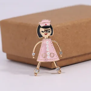 Close-up of a cute nurse enamel brooch with pearls and rhinestones decoration