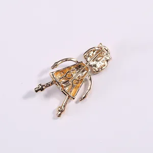 Back view of a golden alloy cartoon nurse brooch featuring a secure safety pin closure
