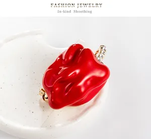 Close-up of a vibrant red chili pepper brooch with rhinestone accents and gold trim