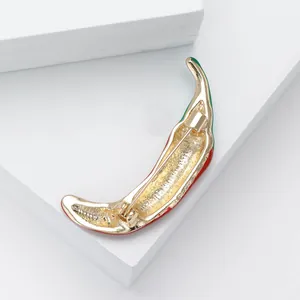 Detailed back view of red enamel chili brooch showing the gold-plated pin mechanism