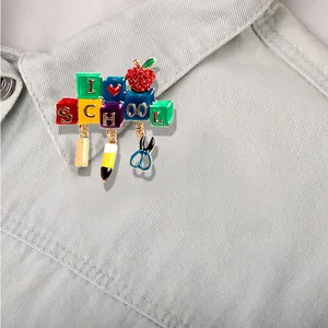 Colorful I Love School brooch pin with pencil and scissors charms on denim