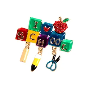 Colorful 'I Heart School' enamel brooch featuring pencil and scissors hanging charms