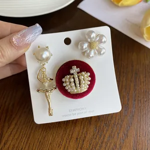Detailed macro shot of vintage pearl ballet girl, crown and flower brooch accessory set