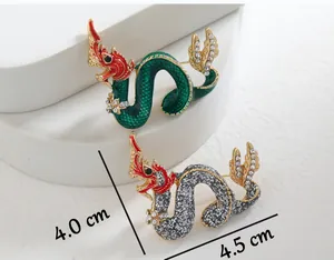 Detailed view of Chinese dragon brooch measuring 4.5cm by 4.0cm with rhinestones