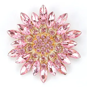 Close-up view of an elegant pink crystal flower brooch with a shiny gold-tone base