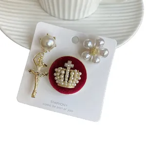 Elegant vintage pearl brooch set featuring ballet girl, flower, and royal crown motifs