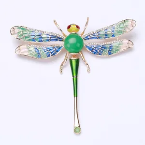 Exquisite dragonfly brooch with green enamel and sparkling crystals on the wings