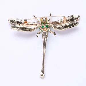 Detailed view of the gold-tone dragonfly brooch back showing the pin mechanism