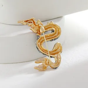 Back view of a vintage Chinese dragon brooch with gold-plated finish and pin closure