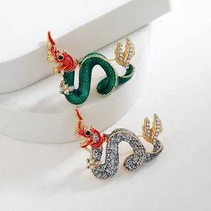Vintage Chinese dragon brooches with enamel finish and sparkling rhinestone accents