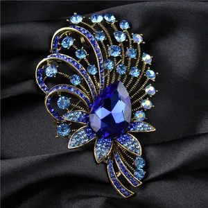 Close-up of elegant palace style crystal brooch featuring blue gemstones on black silk
