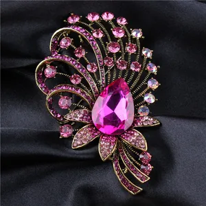 Detailed macro shot of a luxury court-style crystal brooch with pink teardrop stone.