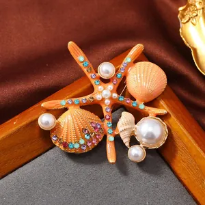 Detailed close-up of a vintage enamel starfish brooch with pearls and colorful crystals